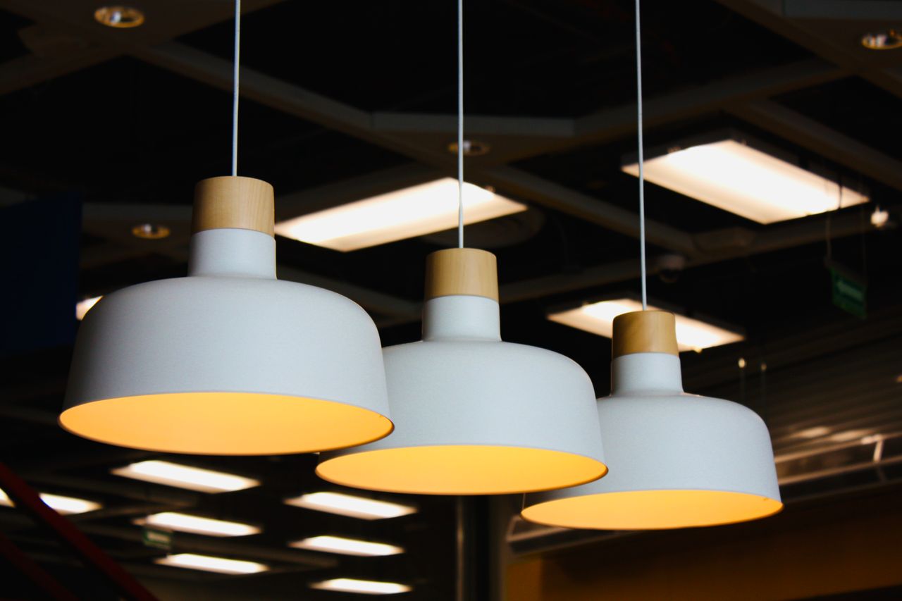 Stylish pendant lights hanging in a modern indoor setting at night, creating a warm ambiance.